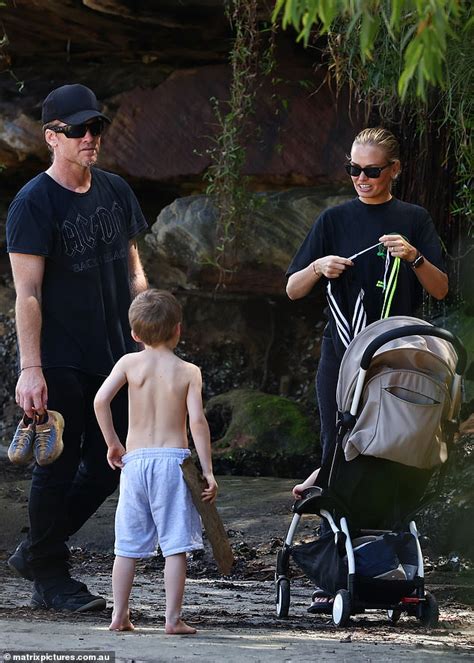 Lara Bingle and her husband Sam Worthington enjoy a beach.